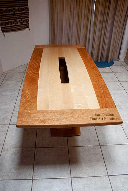 custom made contemporary dining table shown from slightly above showing pegged breadboard end